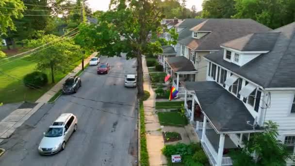 Establishing Shot Cars Driving Small Town Street Pride Flags American — Stock video