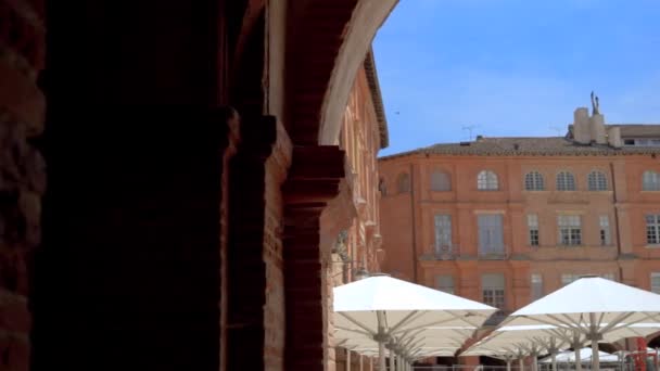 Montauban Town Square Parasol Umbrellas Architectural Brick Arches Dolly Right — стоковое видео