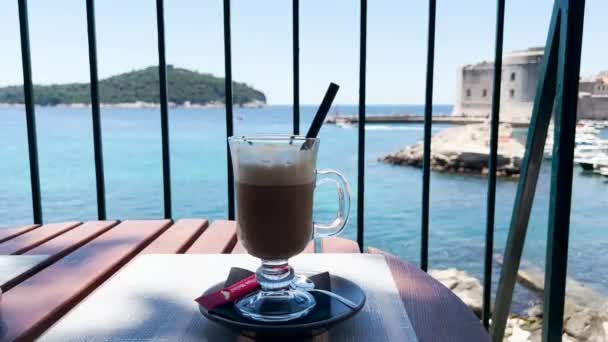 Cup Iced Latte View Blue Sea Rocky Coast Old Town — Vídeo de Stock