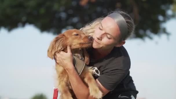 Happy Woman Cuddling Her Dog Licking Her Face Park — Stockvideo