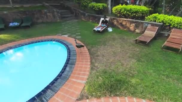 Pull Back Shot Peacock Walking Pool Edge Next Person Laying — Video Stock