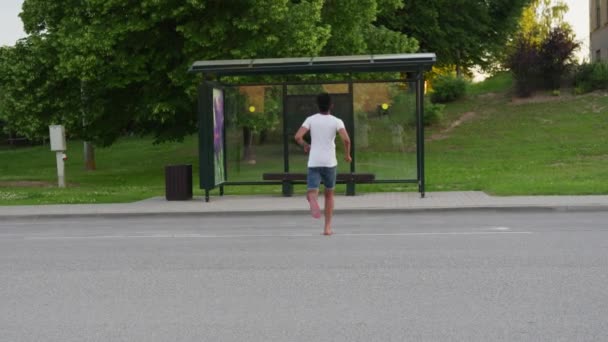 Handheld Shot Young Man Running Bus Stop Stressfully Summer — Stockvideo
