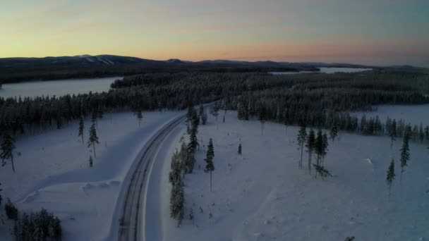 Aerial View Long Curving Snowy Frozen Road Lapland Winter Forest — Stock video