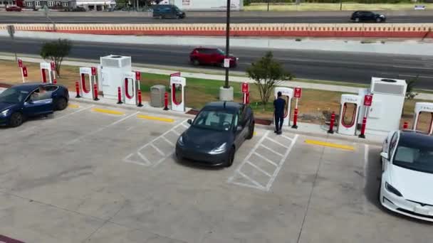 Person Uses Tesla Charger Recharge Electric Vehicle Battery Green Energy — Stock Video