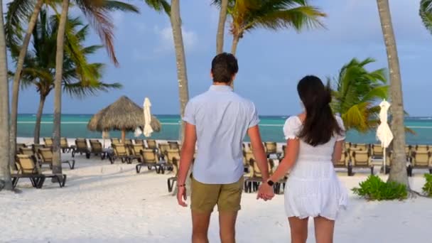 Flirtatious Young Couple Walks White Sandy Beach Magic Hour Light — Video Stock