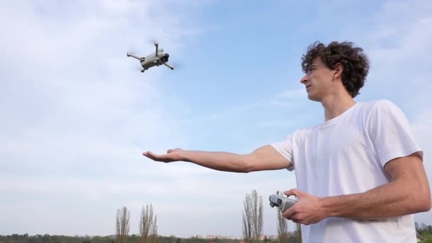 Young Male Drone Landing Small Quadcopter Aircraft Hand Using Controller — Stockvideo