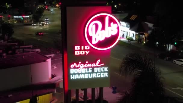 Bobs Big Boy Neon Sign Night Cars Driving Background Aerial — Stock video