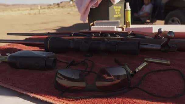 Hunting Rifles Equipment Arranged Table Spent Shell Casings Dolly Shot — Vídeo de Stock