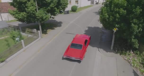 Cinema Drone Follows Construction Year Buick Riviera Driving Thru Village — Stockvideo
