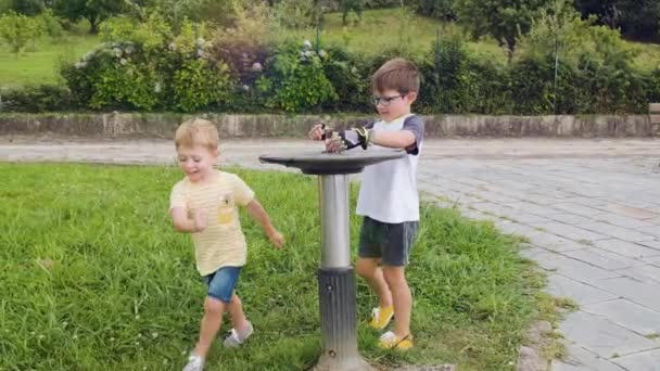 Young Boys Playing Water Drinking Fountain Public Park Slow Motion — Stockvideo