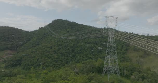 High Voltage Towers Green Hill Slow Aerial Flying Close Cables — Stock Video