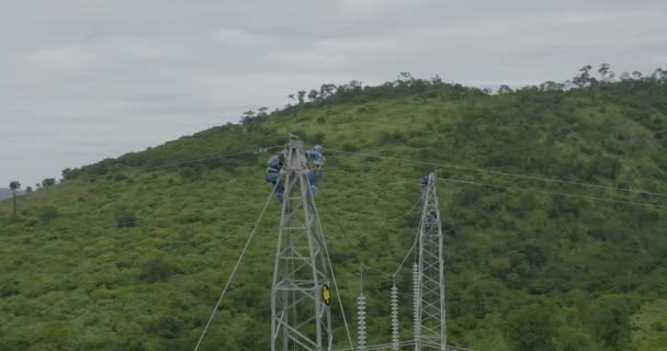 Aerial Circling Unrecognizable People Working Top High Voltage Tower — ストック動画