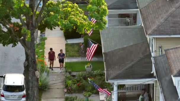 Two People Walking Sidewalk Small Town Suburban America Pride Flags — Αρχείο Βίντεο