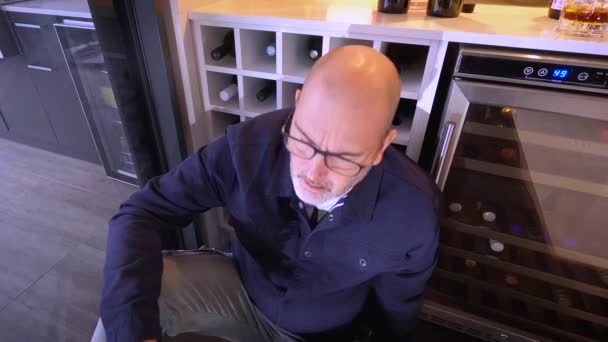 Stressed Man Sits Floor Front Bar Fridge Sculling Glass Wine — Stockvideo