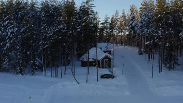 Aerial View Passing Remote Wintertime Snow Covered Woodland Cabin Rising — Video Stock
