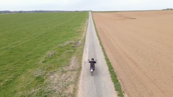 Drone Actively Tracking Accelerating Motorcycle Rider Empty Gravel Road European — 图库视频影像