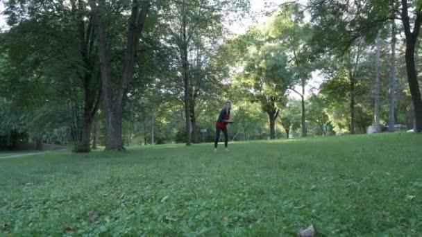 Girl Throwing Frisbee Park Running Camera — Stockvideo