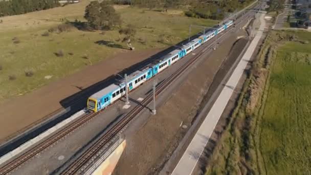 Train Drives Outer Suburbs Aerial Shot Rising — Stockvideo