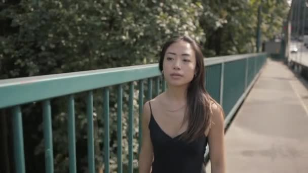 Medium Shot Beautiful Asian Woman Black Walking Green Railing Slowmo — Stockvideo
