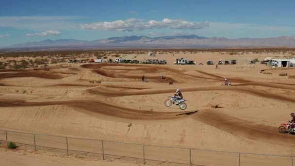 Two Motocross Racers Jumping Ramp Mojave Desert Landscape Track Aerial — Stockvideo