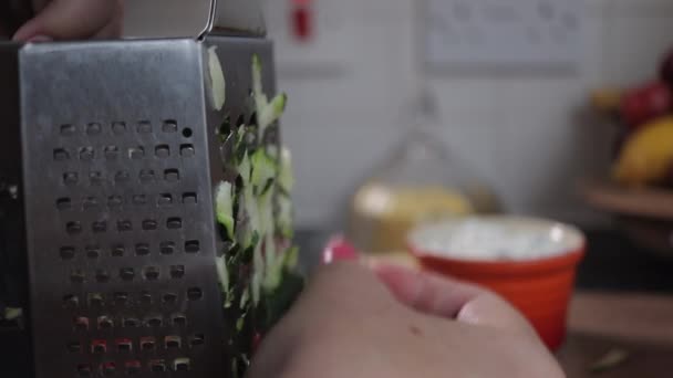 Woman Grating Zucchini Courgette Chrome Grater Wooden Chopping Board Background — Stock Video