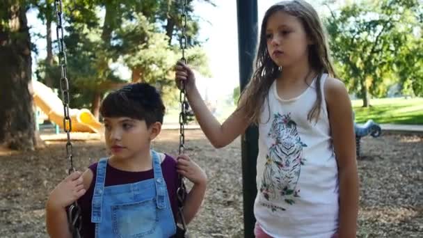 Two Girls Look Serious Listen Someone Swing Set Out Frame — Stok video
