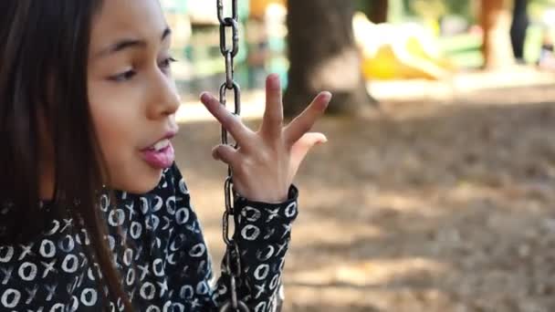 Eleven Year Old Girl Has Spirited Conversation Friends Swing Set — Vídeo de stock