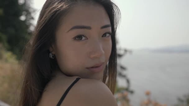 Closeup Cute Asian Girl Smiling Camera Plays Hair Slowmo — Video