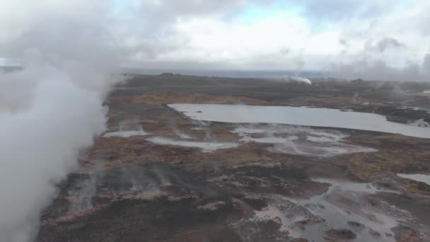 Aerial Panning Shot Geothermal Hot Spring Billowing Steam Ground — Stockvideo