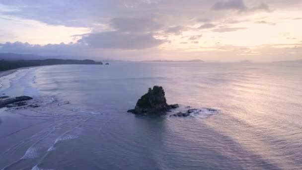 Aerial Tracking Pedestal Tilt Lone Limestone Cliff Calm Ocean Sunset — Stock videók