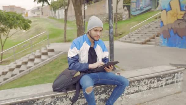 Young Man Using Tablet Park — Video