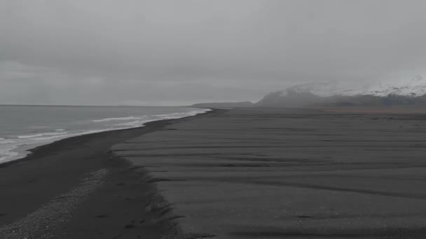 Slow Motion Drone Shot Flying Back Vast Black Sand Beach — Stockvideo