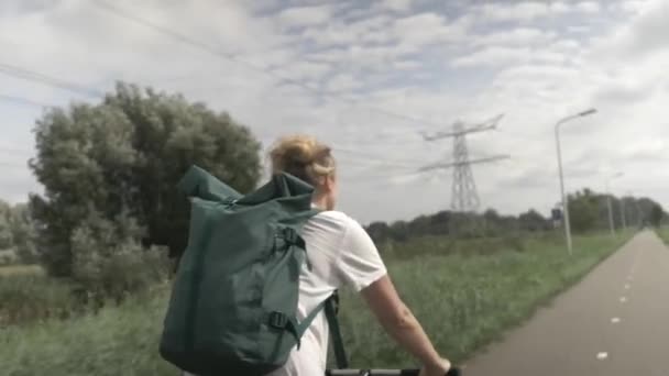 Close Young Woman Cycling Beautiful Dutch Countryside Looking Left Right — Stock Video