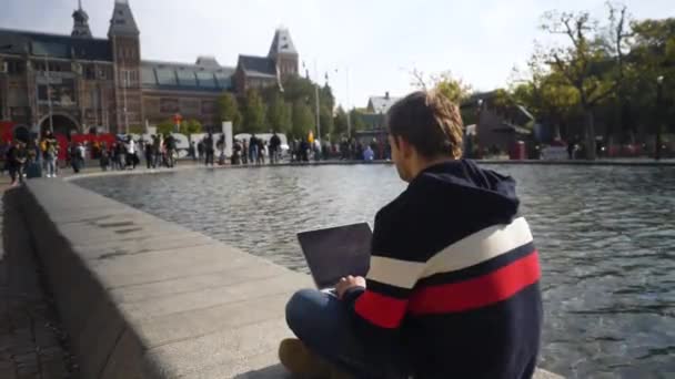 Adult Man Working His Laptop Front Amsterdam Sign Amsterdam Netherlands — Stockvideo