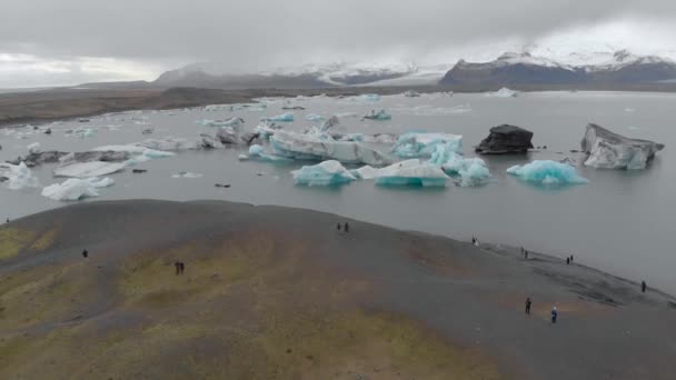 氷河湖を眺める観光客の空中ショット — ストック動画