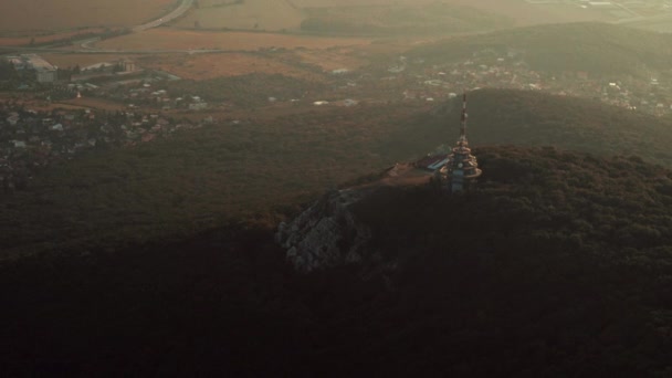 Aerial view of Zobor TV tower on hill at sunset