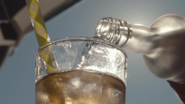 Close Transparent Liquid Being Poured Bottle Glass Backlit Sun Umbrella — Vídeos de Stock