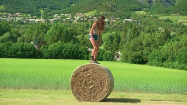 Beautiful Brunette Woman Standing Balancing Carefully Large Bale Hay Farm — Stock Video