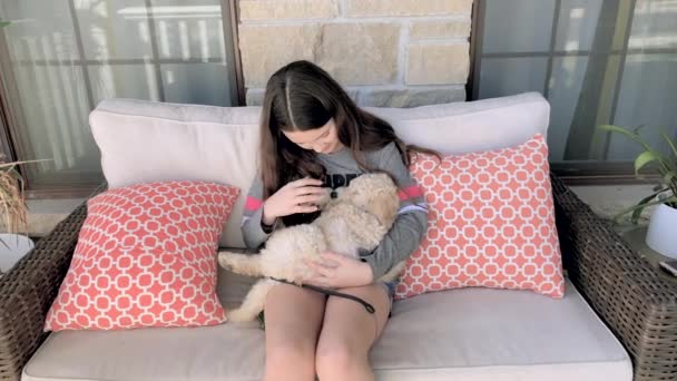 Cute Golden Doodle Puppy Sleeps Little Girl Lap Porch — Stock video