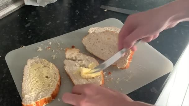 Rushing Man Haphazardly Buttering Bread — Stockvideo