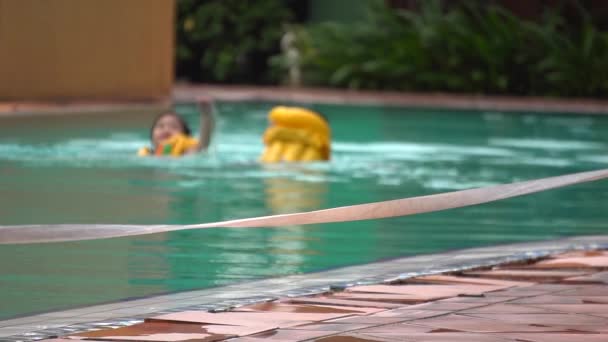 Slow Motion Southeast Asian Kids Swimming Splashing Pool Amongst Orange — Stockvideo