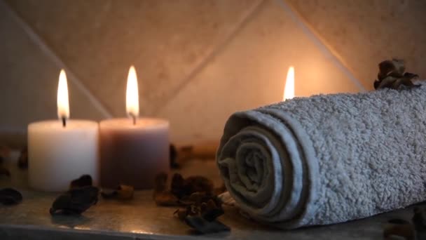 Relaxing Spa Background Candles Flickering Flames Some Wooden Petals Towel — Stockvideo