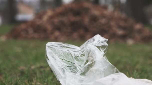 Tilt Shift Garbage Plastic Bag Floor Leaves Stack Wooden House — Vídeo de Stock