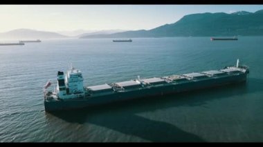 A large ship anchored offshore of the coast of Vancouver