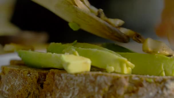 Closeup Female Putting Mushroom Topping Avocado Toast Young White Woman — Vídeo de Stock