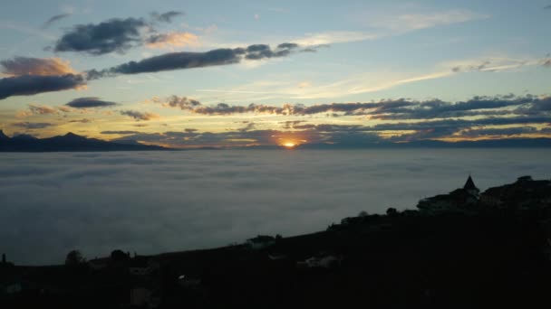 Aerial Shot Passing Small Village Edge Sea Fog Covering Lake — Vídeos de Stock