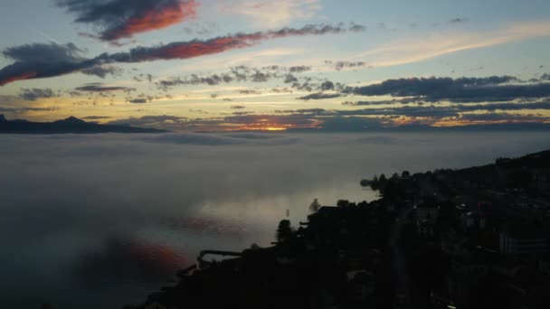 Aerial Passing Lake Shore Descending Fog Patches Reflecting Water Sunset — Stok video