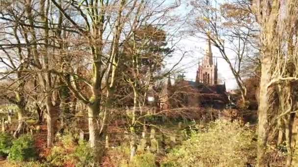 Left Panning Shot Looking Autumn Leafless Trees Churchyard Church Background — ストック動画