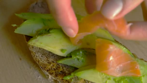 Top View Female Putting Salmon Avocado Toast Close White Young — Stok Video