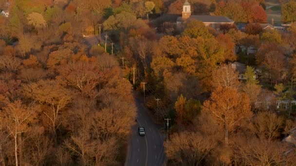 Aerial Winding Road Church Autumn Cars Drive Camera Tilts — Stock videók